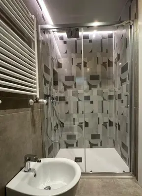 a bathroom with a shower and a sink and a tub at House Spa Palermo in Palermo