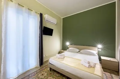 a bedroom with a bed with two towels on it at Ramona House in Palermo