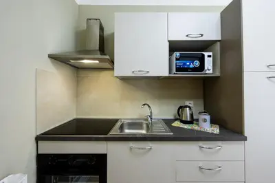 a small kitchen with a sink and a microwave at Anita House in Palermo