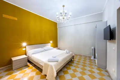 a bedroom with a bed and a chandelier at Anita House in Palermo