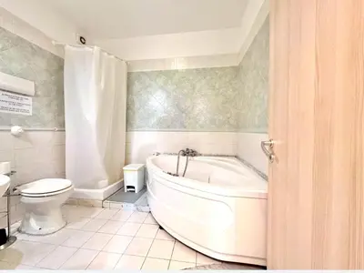 a bathroom with a white tub and a toilet at Sant'Oliva House Palermo in Palermo