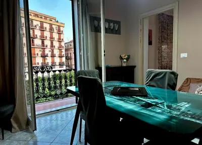 a table and chairs with a view of a balcony at Sant'Oliva House Palermo in Palermo