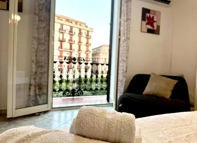 a living room with a couch and a large window at Sant'Oliva House Palermo in Palermo