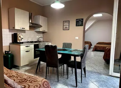 a kitchen and dining room with a table and chairs at Sant'Oliva House Palermo in Palermo