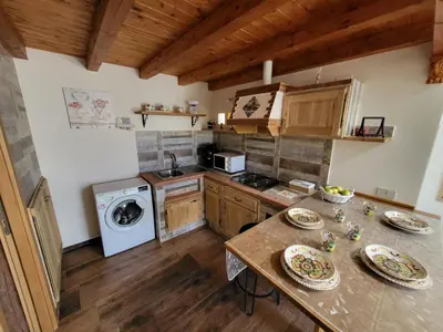 a kitchen with a table with plates on it at marino casa vacanze in Carini