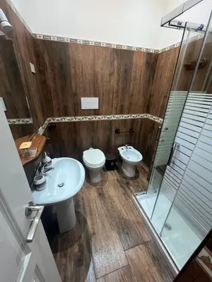a bathroom with a toilet and a sink and a shower at marino casa vacanze in Carini