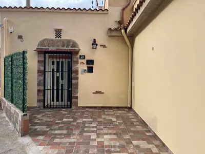 a door to a building with a cross on the wall at marino casa vacanze in Carini