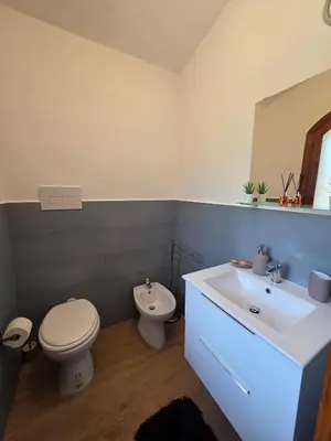 a bathroom with a toilet and a sink at Villa Giacoma hot tub and garden in Mandra Capreria