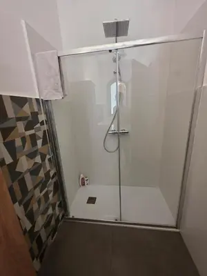 a shower with a glass door in a bathroom at Villa Giacoma hot tub and garden in Mandra Capreria