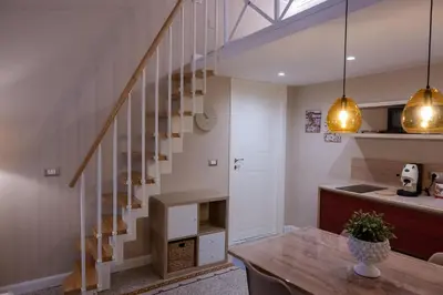 a kitchen and dining room with a staircase in a house at Casa SMART in Palermo