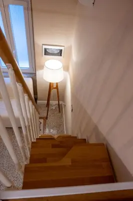 a stairway with a lamp and a stair case at Casa SMART in Palermo