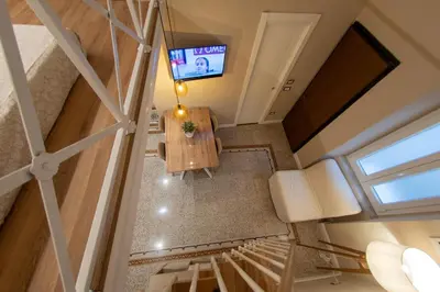 an overhead view of a living room with a table and a television at Casa SMART in Palermo