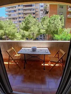 a table and two chairs on a balcony at una casa tranquilla in Palermo