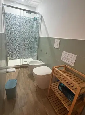 a bathroom with a toilet and a shower at una casa tranquilla in Palermo