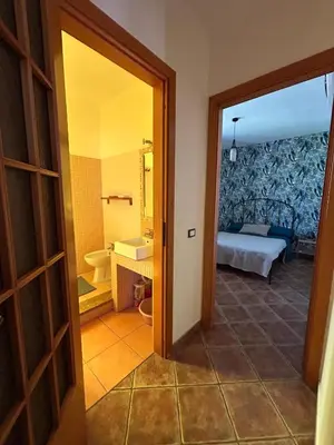 a room with a bathroom with a bed and a mirror at Villa Irene in Isola delle Femmine