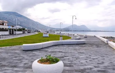 a row of white planters on a sidewalk near the water at Lovely Home In Isola Delle Femmine With Wifi in Isola delle Femmine