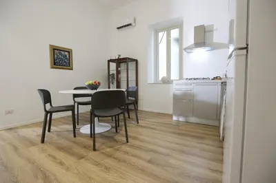 a kitchen and dining room with a table and chairs at Devalù Politeama - Elegante appartamento al Politeama in Palermo