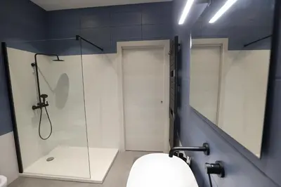 a bathroom with a glass shower and a sink at Devalù Politeama - Elegante appartamento al Politeama in Palermo