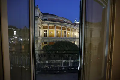 a view of a building at night from a window at Devalù Politeama - Elegante appartamento al Politeama in Palermo