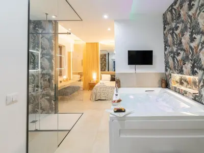 a bedroom with a large bed and a bath tub at Cupido Apartment in Palermo