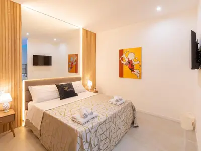 a bedroom with a bed and a tub in it at Cupido Apartment in Palermo