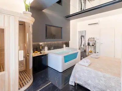 a bedroom with a bed and a hot tub at Cupido Apartment in Palermo