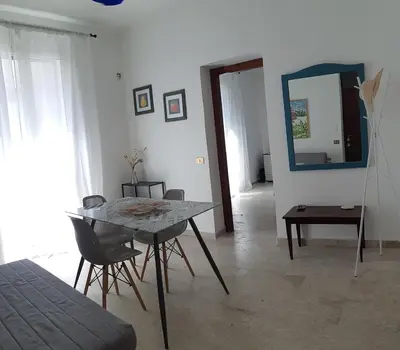 a dining room with a table and chairs and a mirror at Borgo Vivo in Palermo