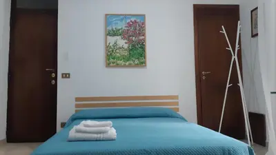a bedroom with a blue bed with towels on it at Borgo Vivo in Palermo