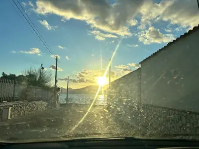 a view of the sun setting over the water at Via dei mirtilli in Carini