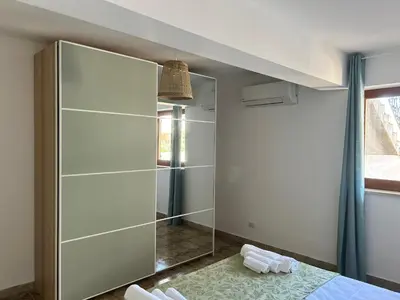 a bathroom with a shower and a glass door at Via dei mirtilli in Carini