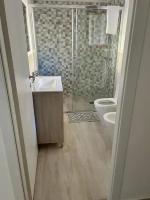 a bathroom with a shower and a sink and a toilet at Via dei mirtilli in Carini
