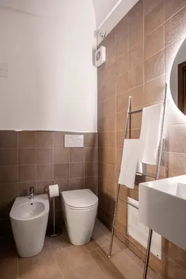 a bathroom with a toilet and a sink at La Casa del Genio in Palermo