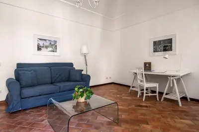 a living room with a blue couch and a table at La Casa del Genio in Palermo