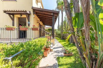 a garden with potted plants and a building at Antonio Family House a Mondello by Wonderful Italy in Palermo