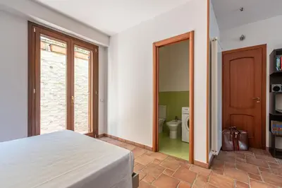 a bedroom with a bed and a bathroom with a toilet at Antonio Family House a Mondello by Wonderful Italy in Palermo