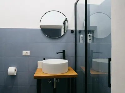a bathroom with a sink and a mirror at La casa di giù in Palermo