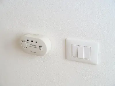 a white electrical outlet on a white wall at La casa di giù in Palermo