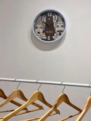 a clock hanging on a wall above a shelf at Moonlight Rooms in Termini Imerese