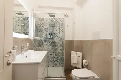 a bathroom with a toilet and a sink and a shower at Nuovo appartamento sul mare immerso nel verde in Palermo