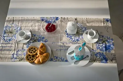 a table with a plate of bread and a cup of coffee at Case Della Baia in Castellammare del Golfo