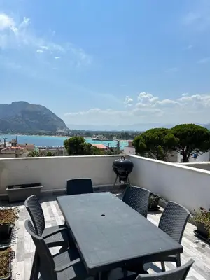 a table and chairs on a balcony with a view at MondHello a 2 passi dal mare in Palermo
