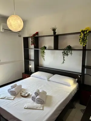 a bedroom with a bed with towels on it at MondHello a 2 passi dal mare in Palermo