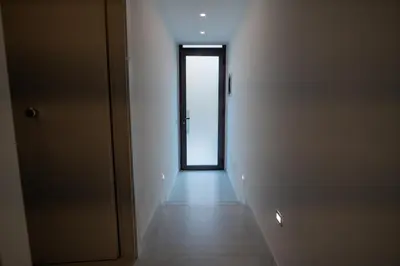 an empty hallway with a door in a room at Ricci & Capricci Exclusive Room in Aspra