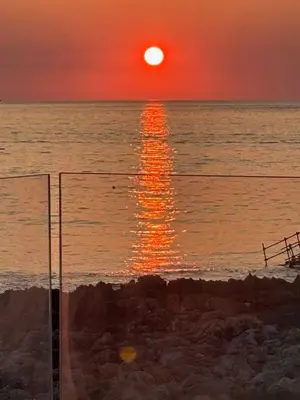 a sunset over the ocean with the sun setting at Palermo sul mare di Isola delle Femmine in Isola delle Femmine
