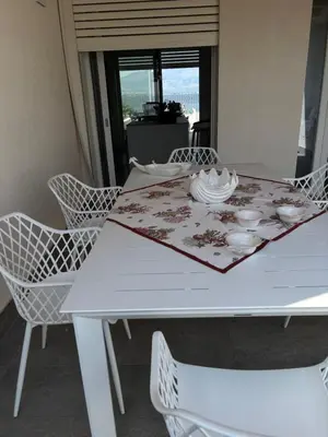 a white dining room table with chairs and a table cloth at Palermo sul mare di Isola delle Femmine in Isola delle Femmine