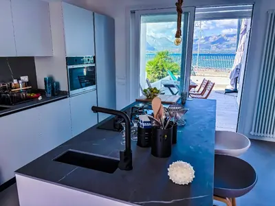 a kitchen with a sink and a view of the ocean at Palermo sul mare di Isola delle Femmine in Isola delle Femmine