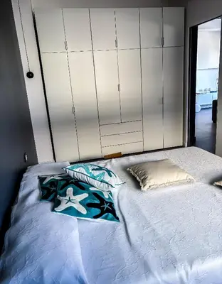 a bedroom with a bed with white cabinets at Palermo sul mare di Isola delle Femmine in Isola delle Femmine