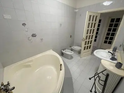 a bathroom with a tub and a toilet and a sink at Alta Marea Mondello - Palermo in Palermo