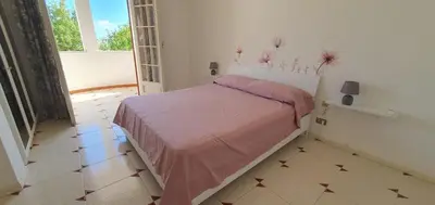 a bedroom with a bed in a room with a window at Alta Marea Mondello - Palermo in Palermo