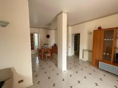 a kitchen and dining room with a table and chairs at Alta Marea Mondello - Palermo in Palermo